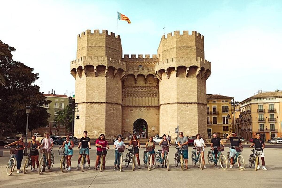 a group of people on bikes in front of a castle