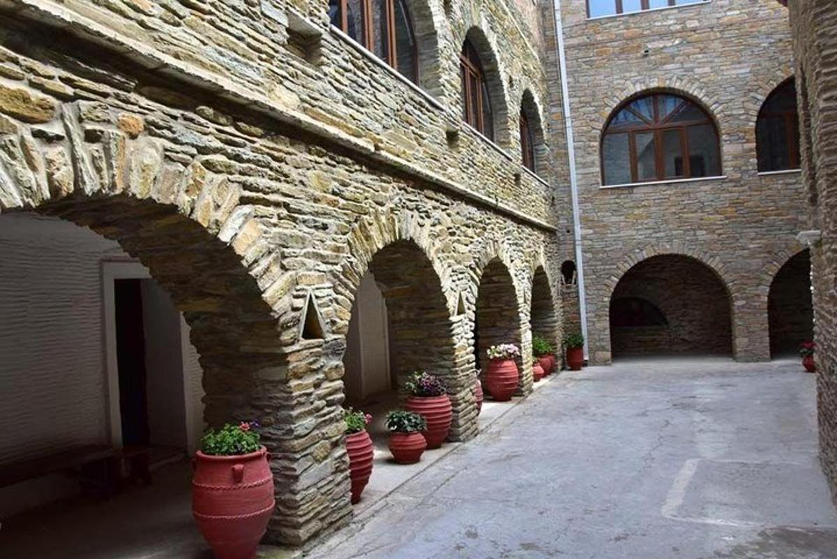 a row of flower pots lined up against a brick building