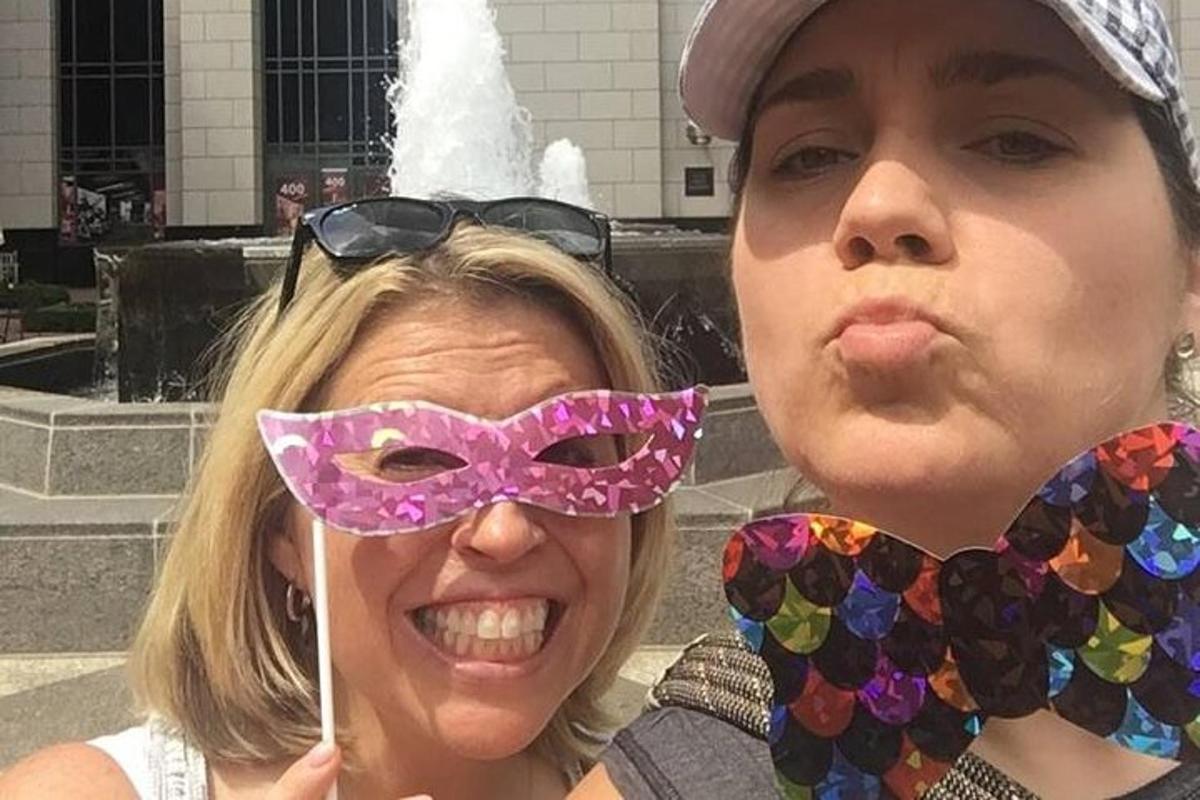 two women wearing masks and glasses posing for a picture