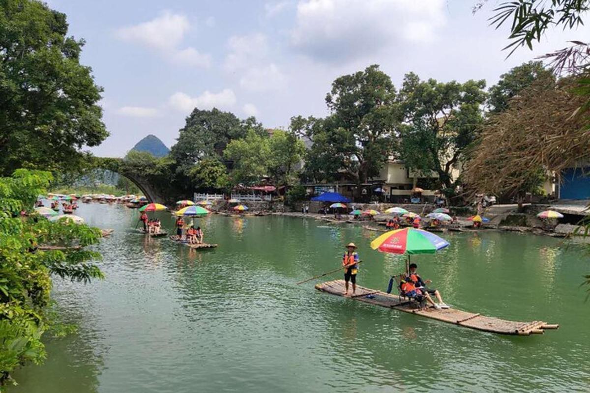 two groups of people on boats in the water with umbrellas