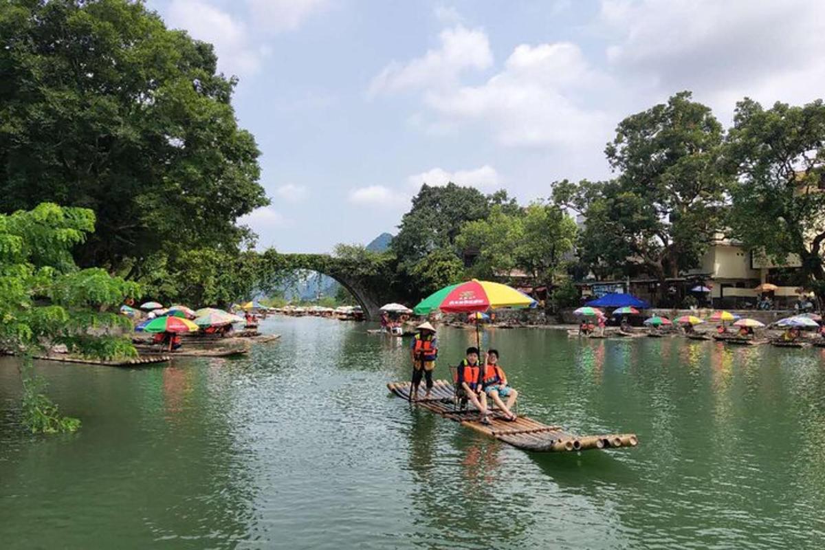 two people on a raft in a river with umbrellas