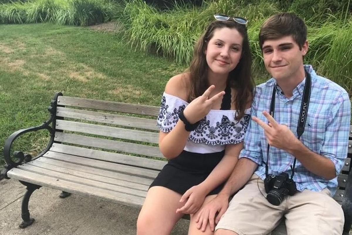 a man and a woman sitting on a bench