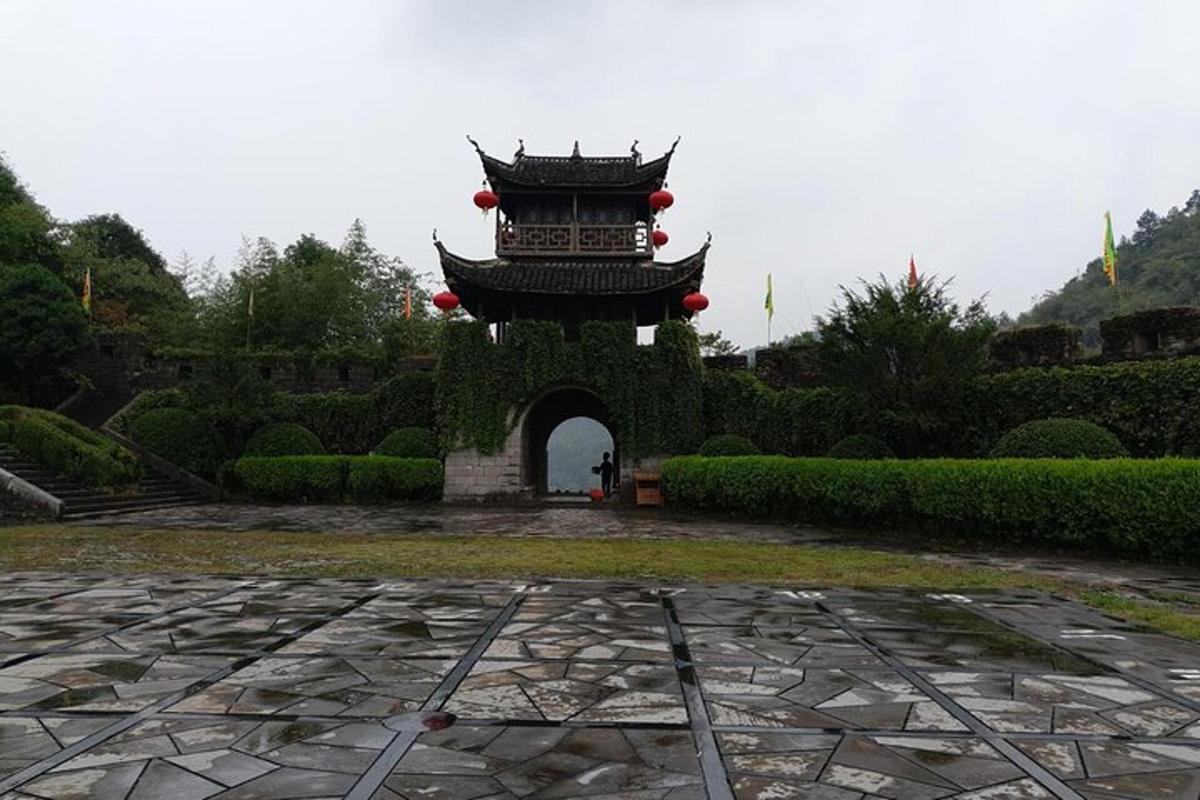 a building with an arch in a garden
