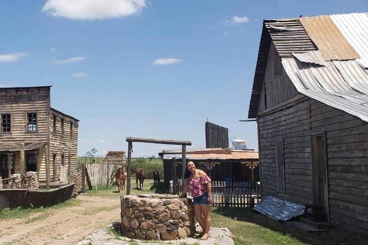 a woman standing next to a wooden building