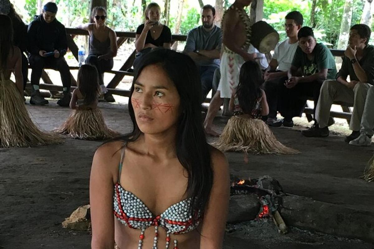 a woman in a bikini sitting in front of a group of people