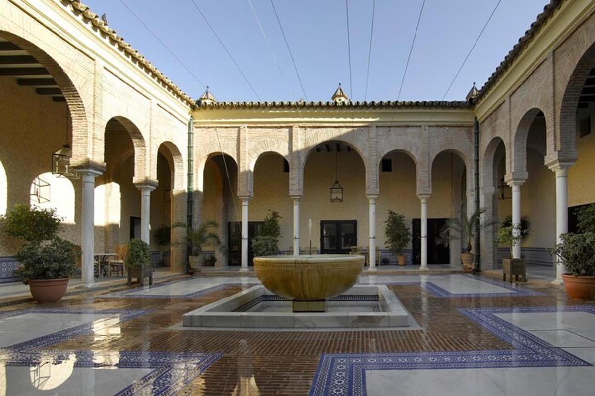 a large courtyard with a fountain in the middle of a building