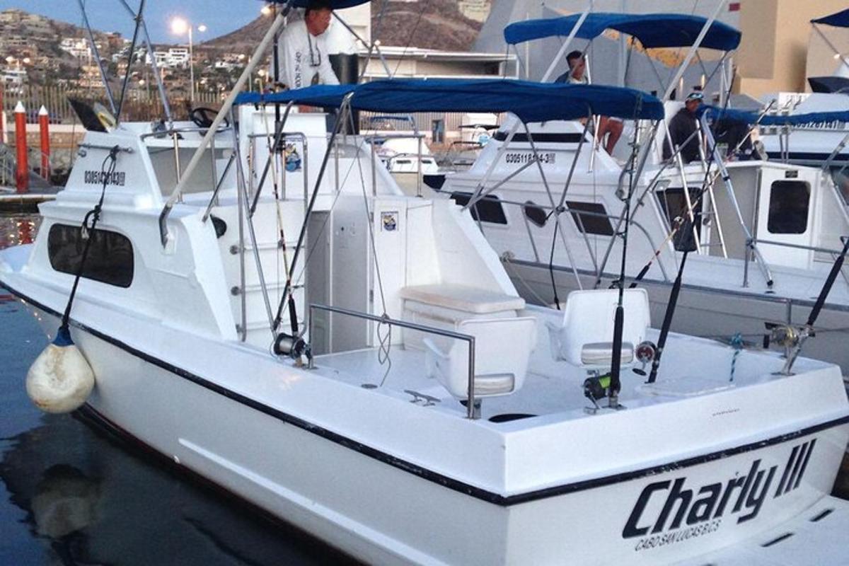 a white boat is docked in the water