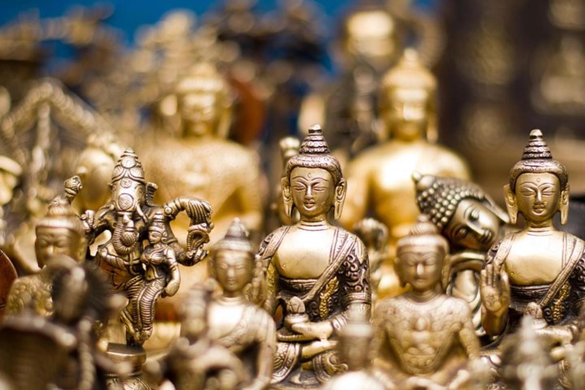 a group of gold buddha figurines are displayed