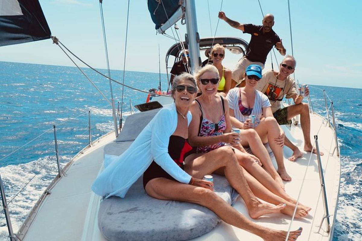 a group of people sitting on the back of a boat