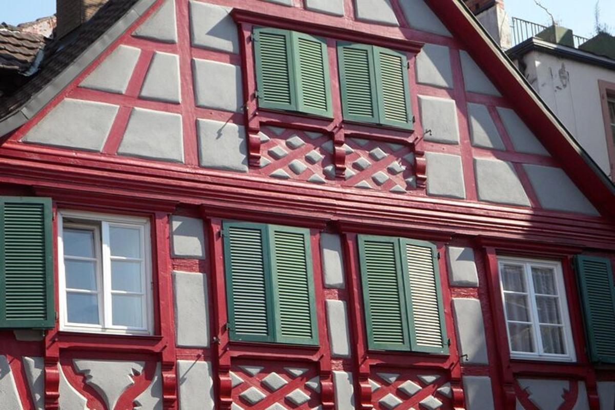 a red and white building with green shuttered windows