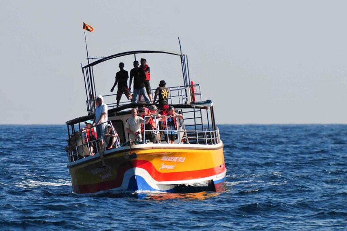 a group of people on a boat in the water