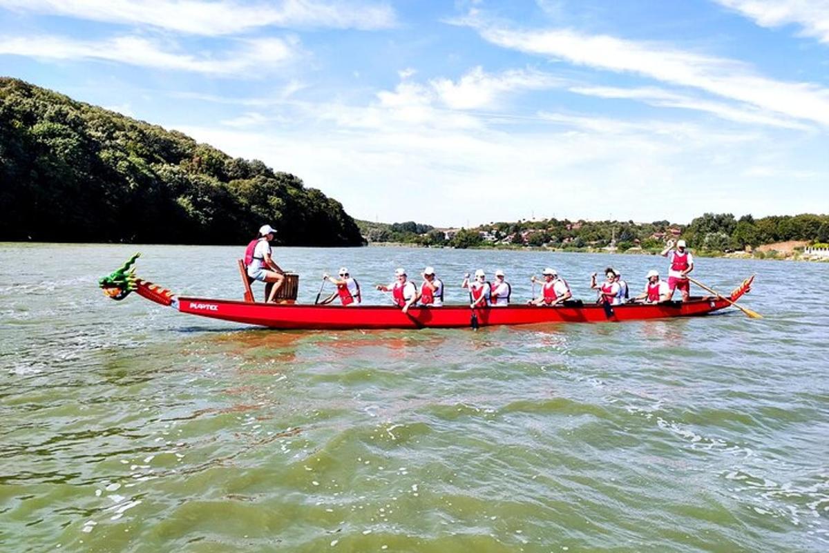 a group of people in a red boat on the water