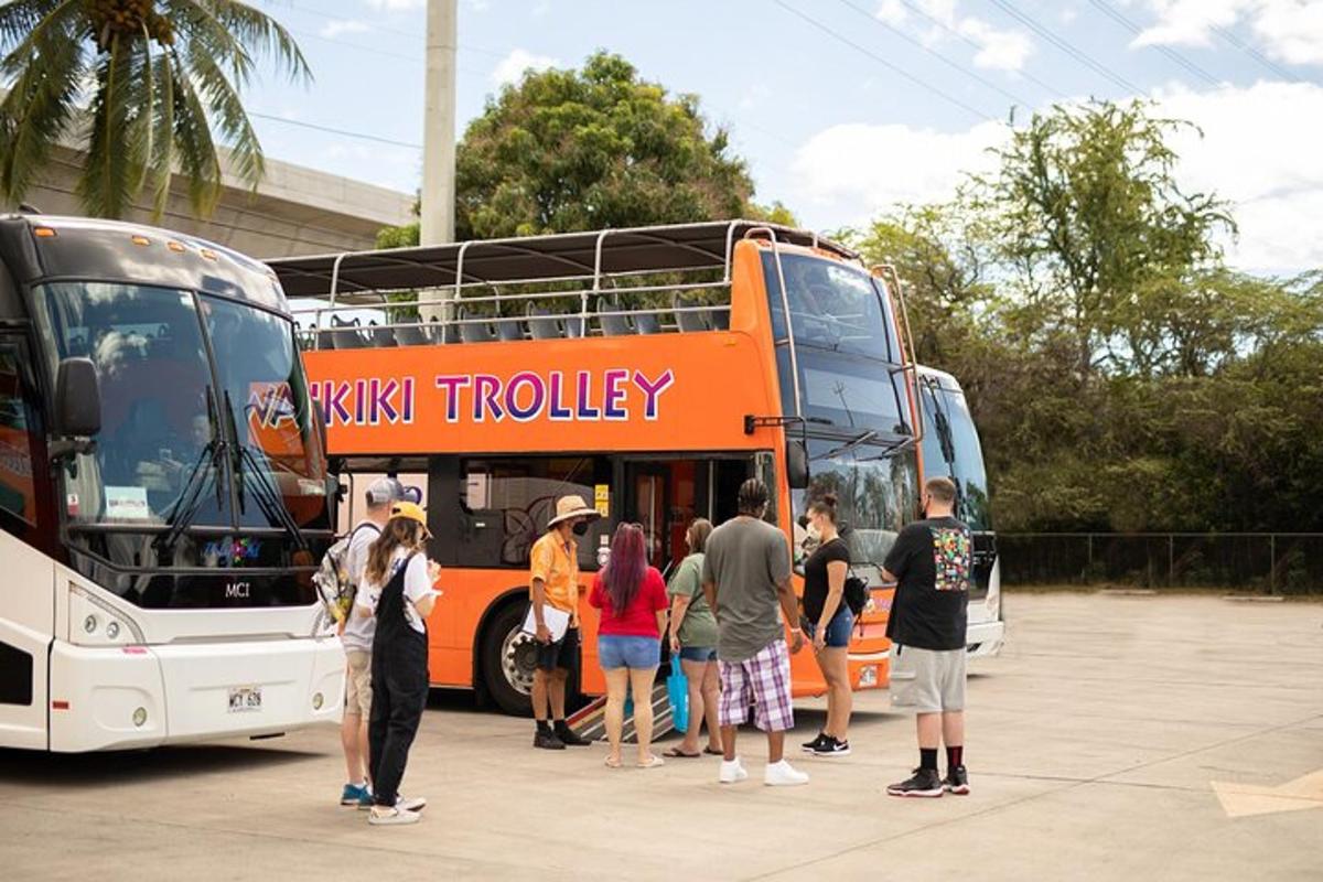 a group of people standing outside of a double decker bus