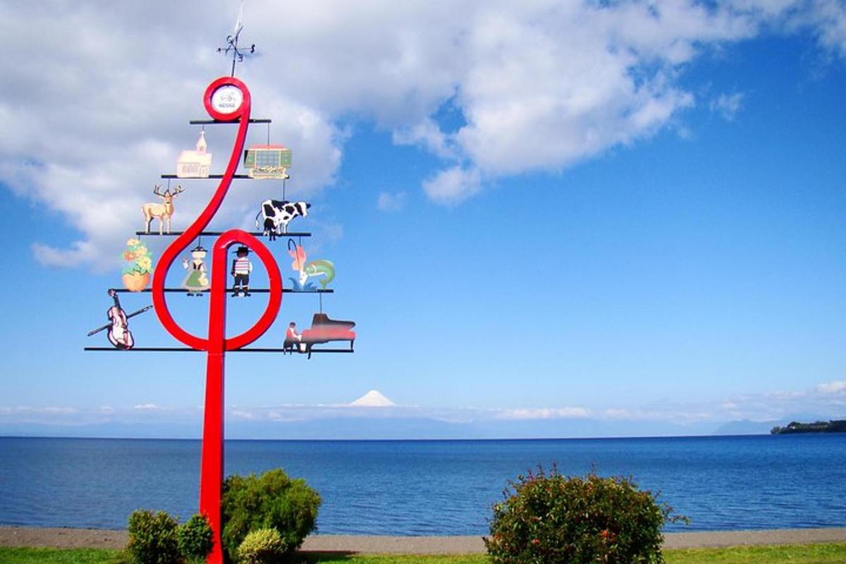 a christmas tree with a clock on it next to the ocean