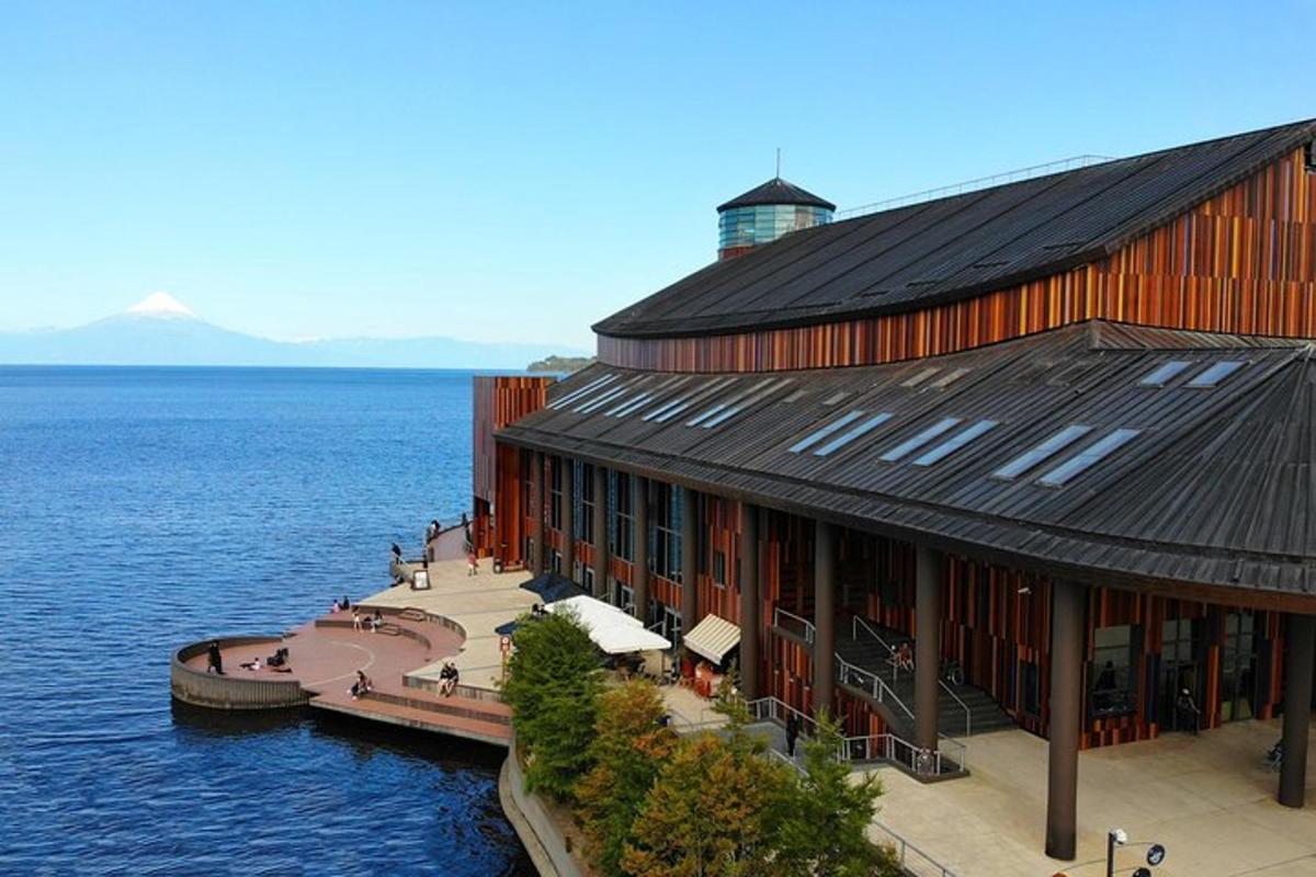 a large building on the water next to the ocean