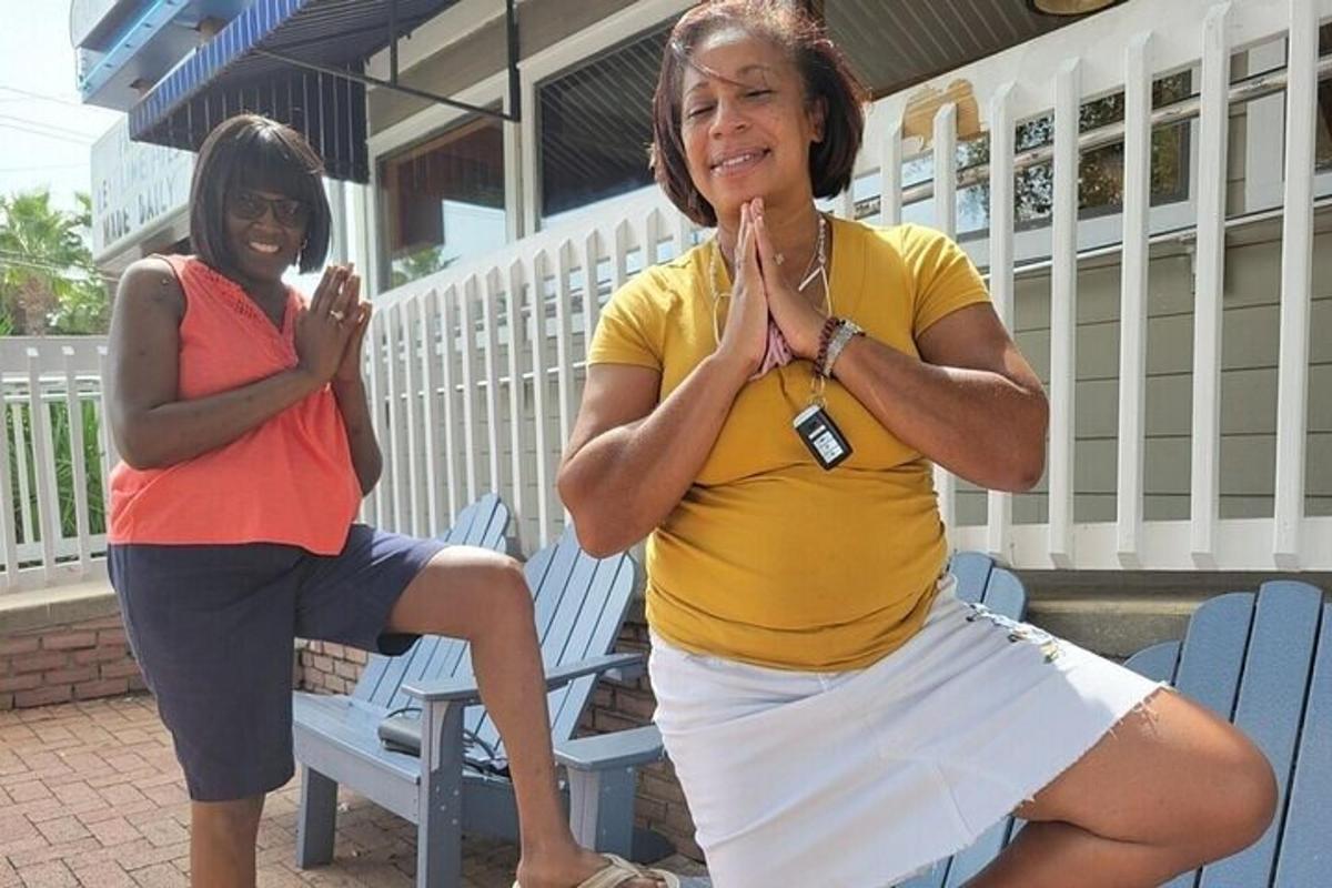 two women sitting on a bench with their hands together