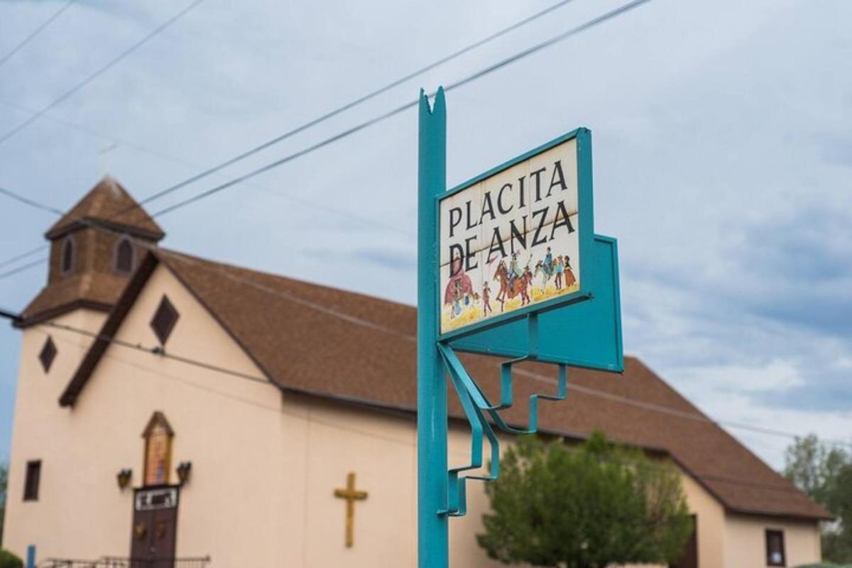 a sign on a blue pole in front of a church