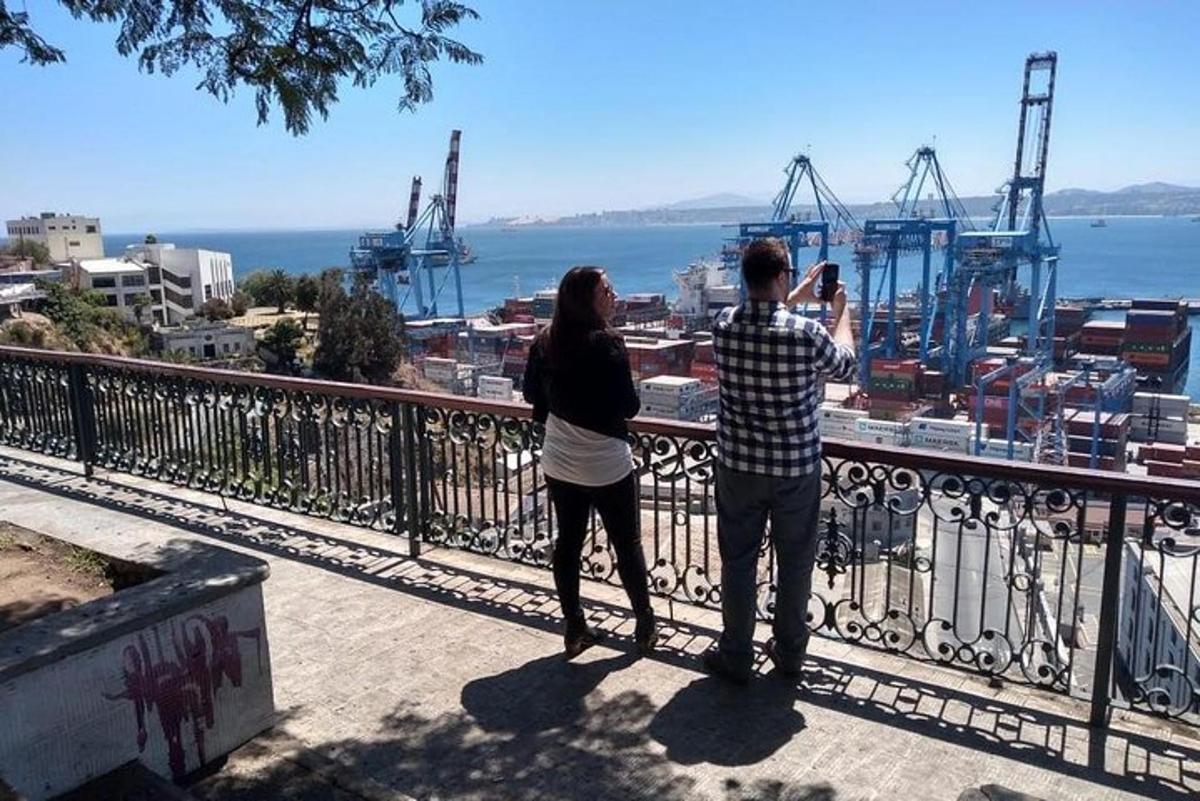 a man and a woman taking a picture of a harbor