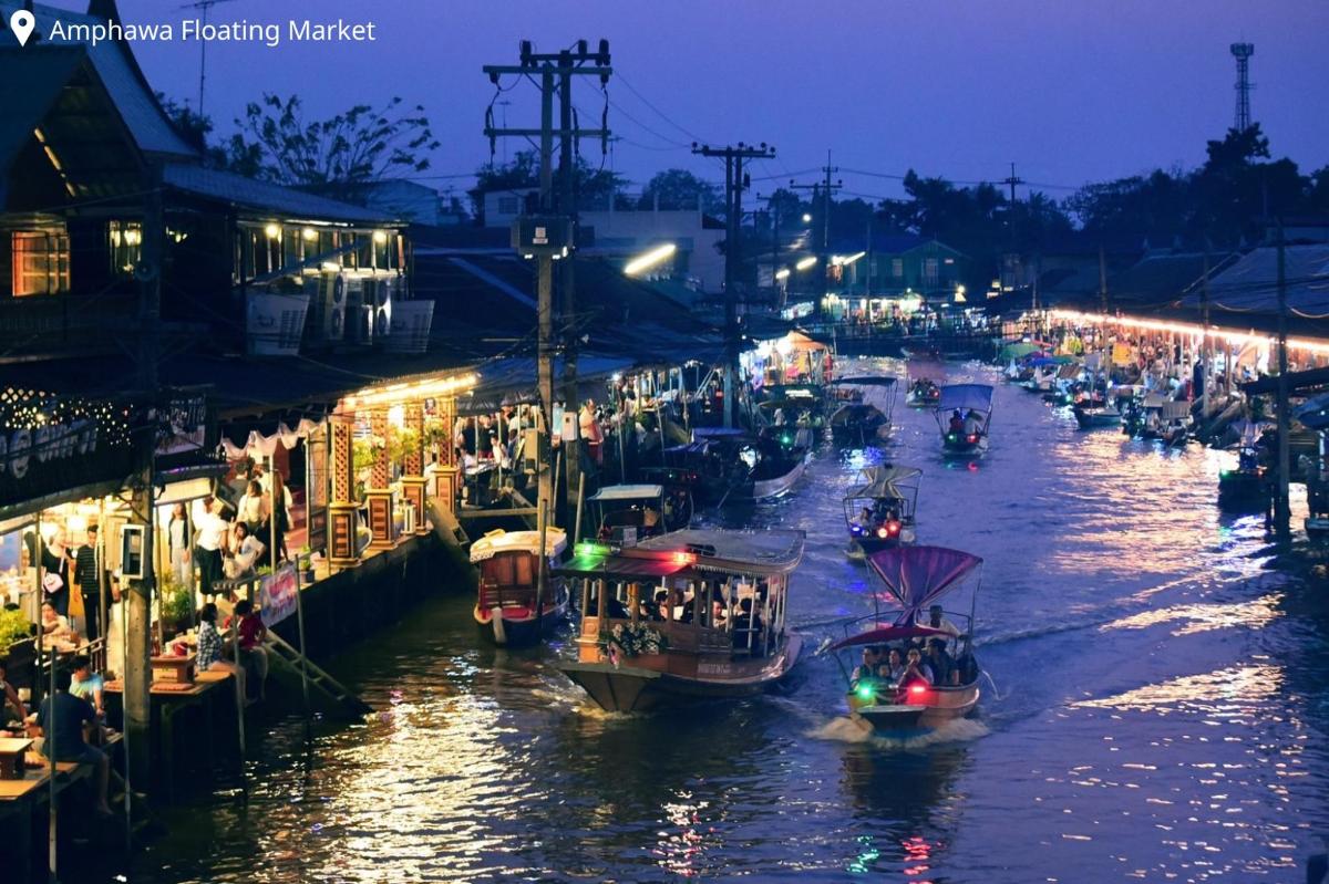 a group of boats in a river at night