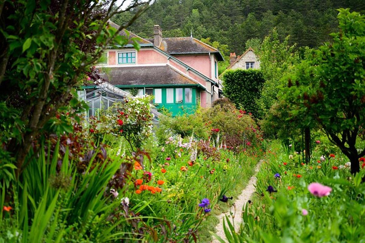 a house with a garden with flowers in front of it