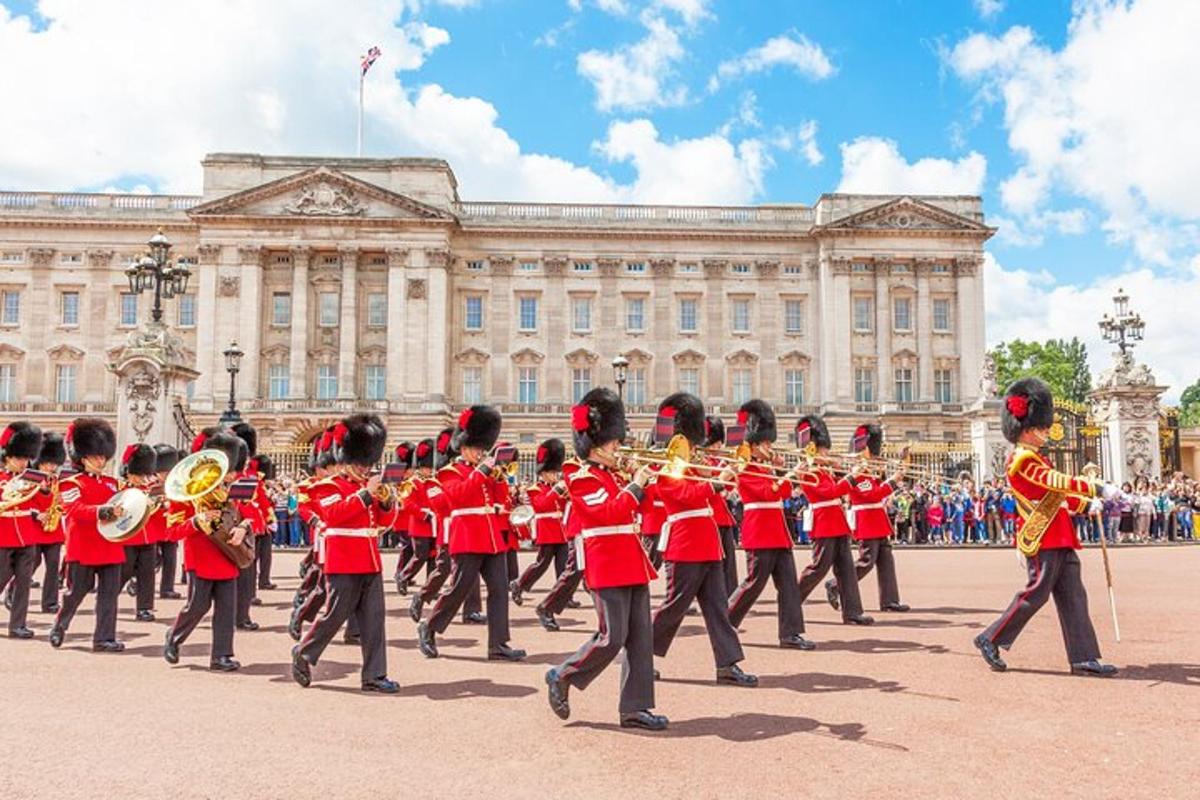 a marching band in red uniforms in front of a building