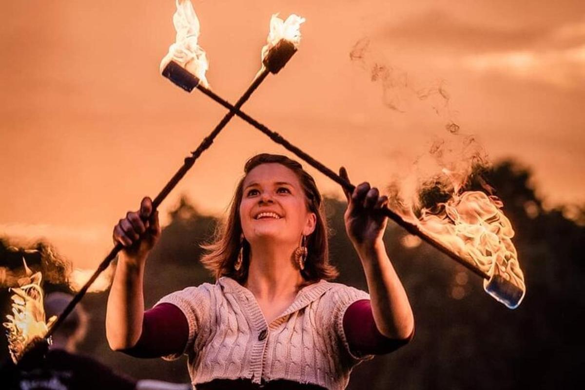 a young girl holding two sticks with smoke