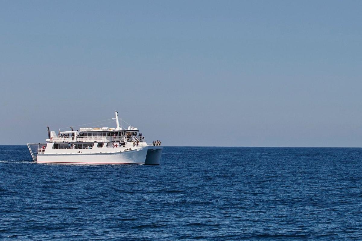 a white boat in the middle of the ocean