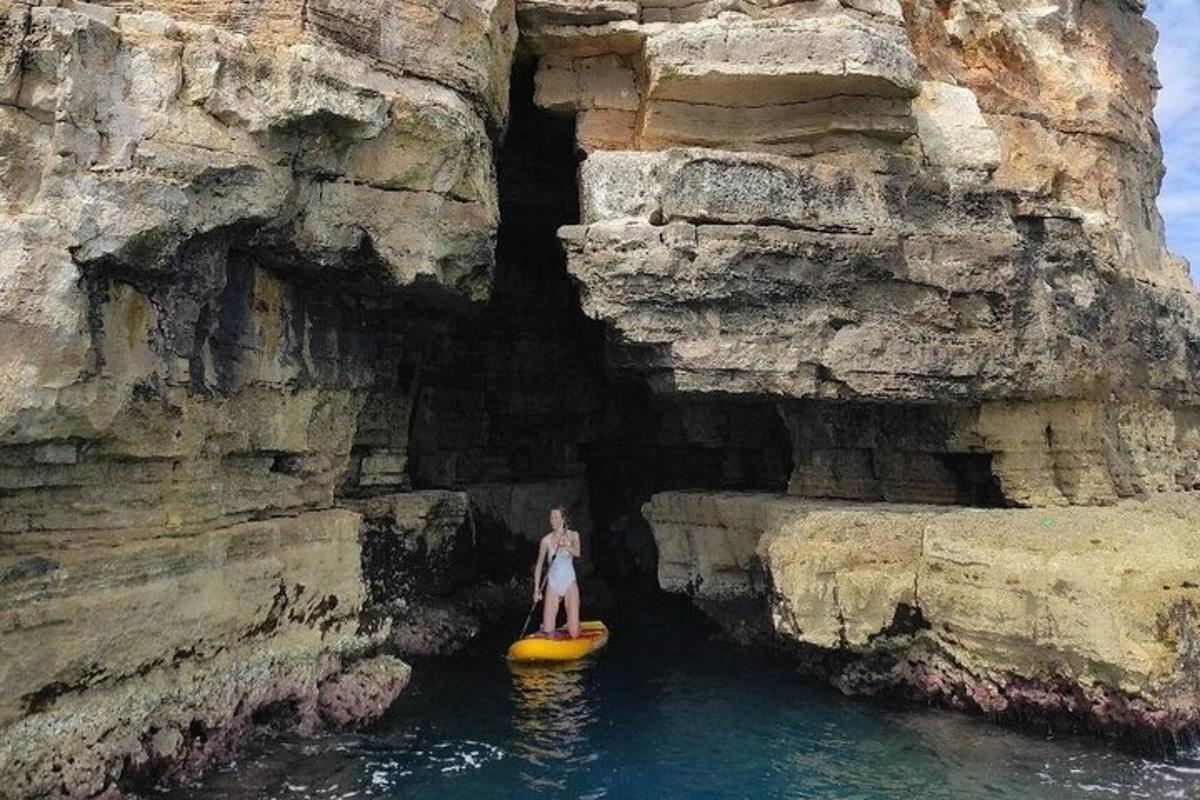 a person is standing on a kayak in the water