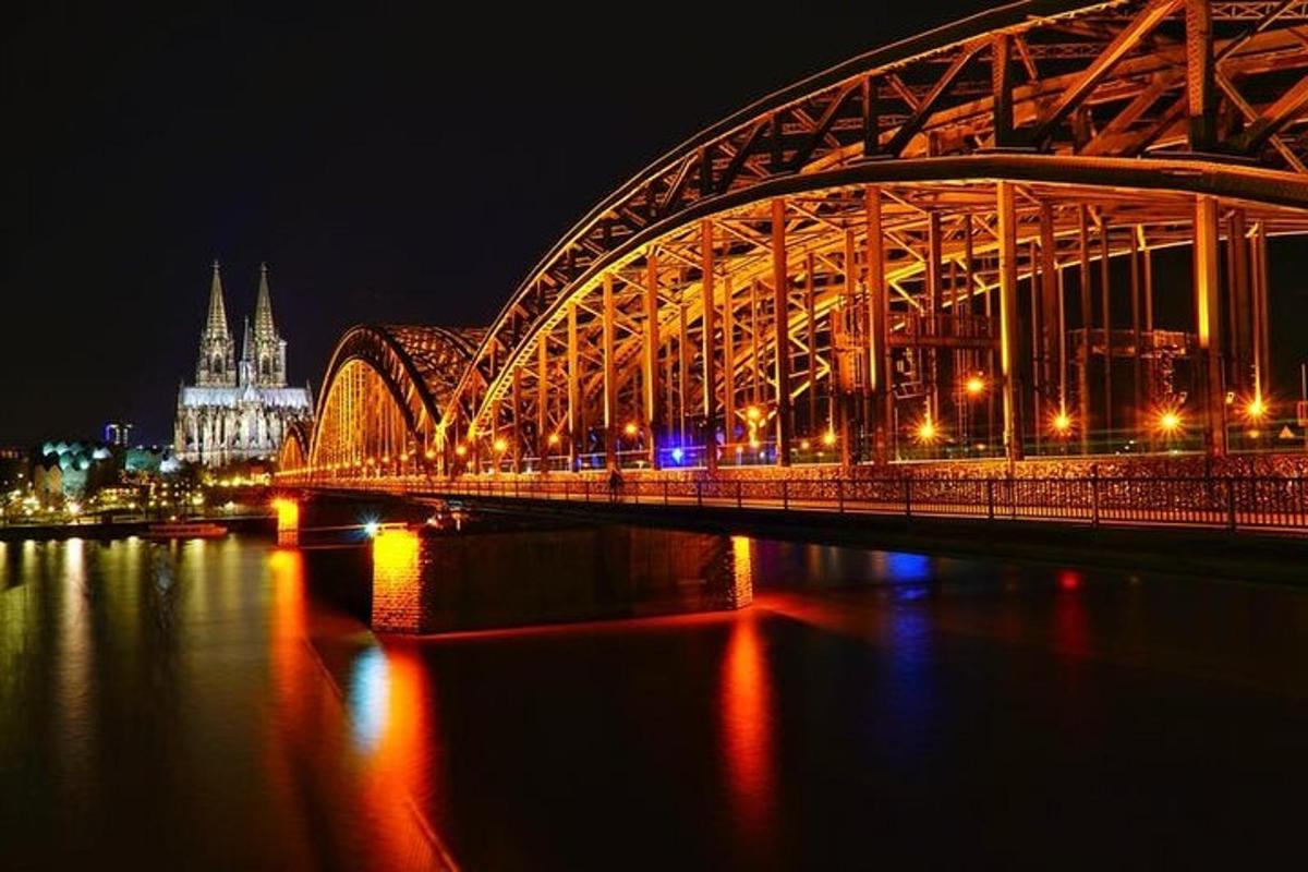 a bridge over a river at night with a city