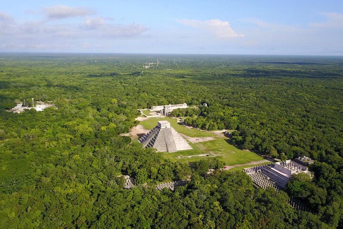 an aerial view of a building in the middle of a forest