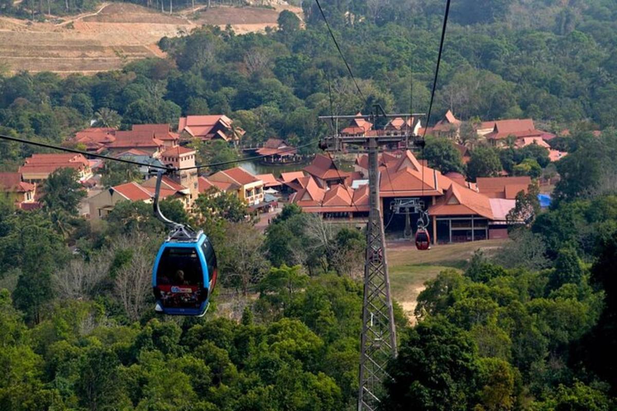 a gondola flying over a village with houses