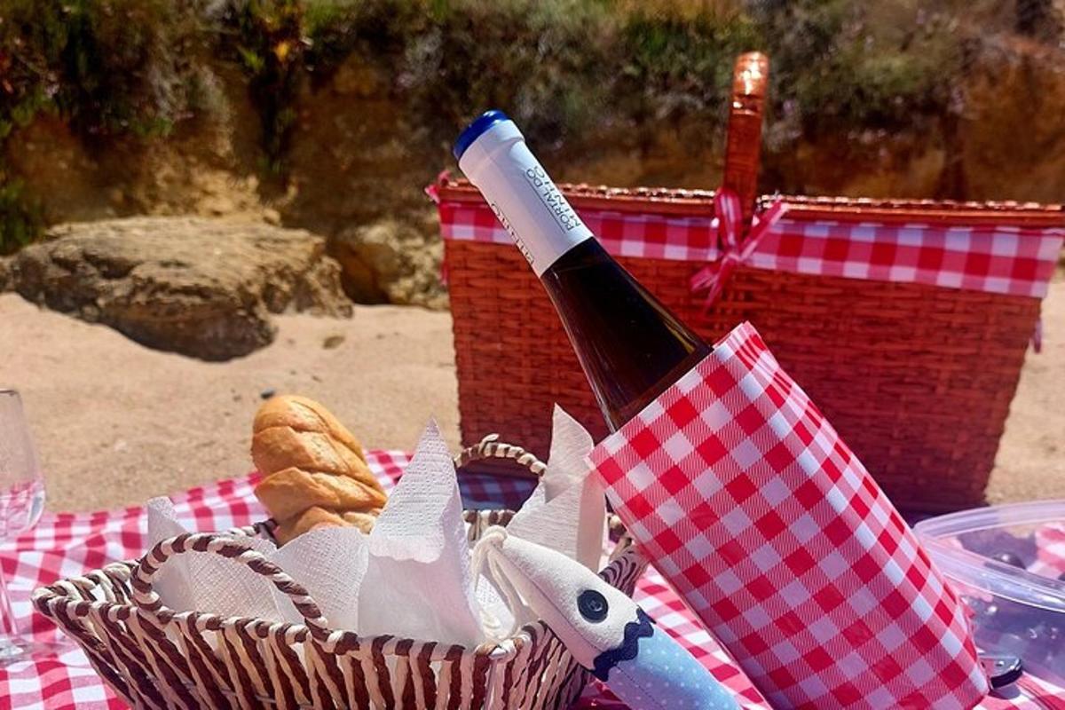 a bottle of wine in a basket on a picnic blanket