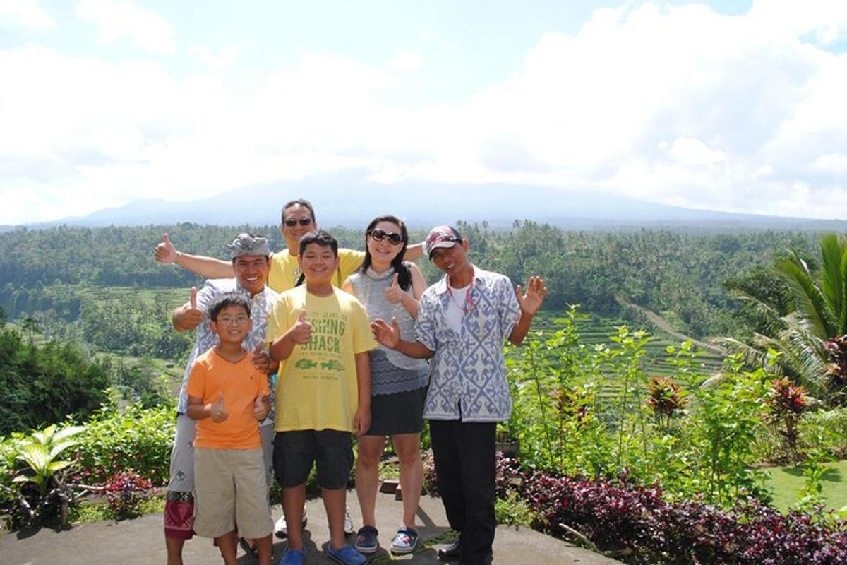 a family posing for a picture on top of a mountain