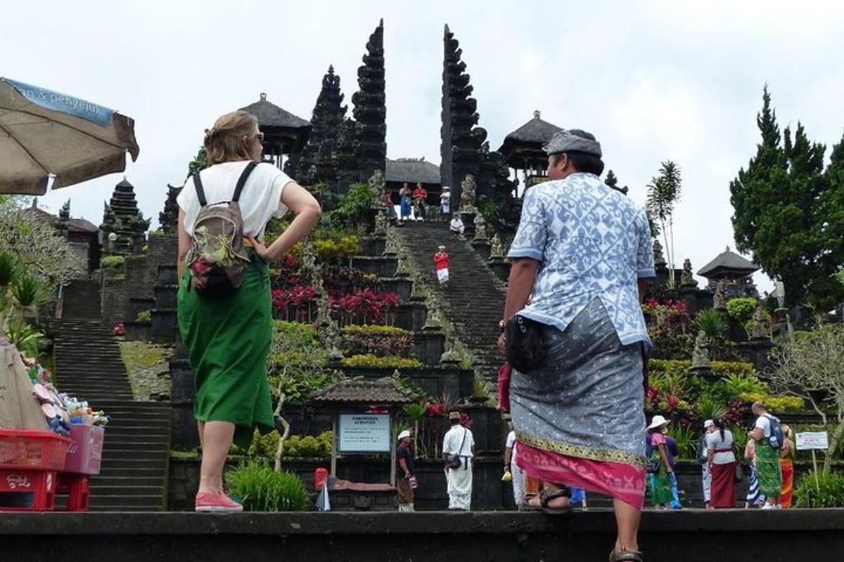 a man and a woman standing in front of a garden