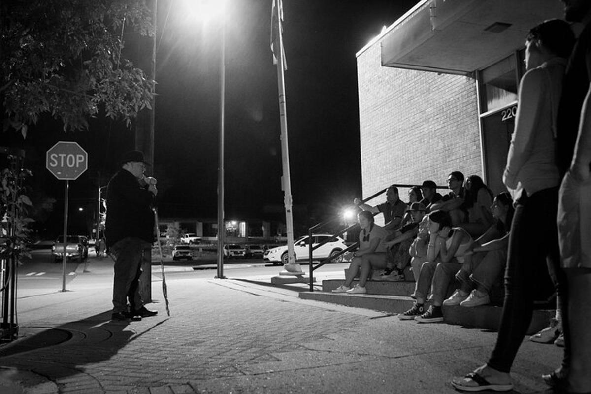 a group of people standing on a street at night