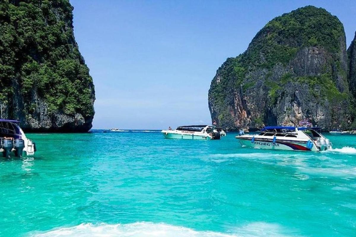 a group of boats in the water near a beach