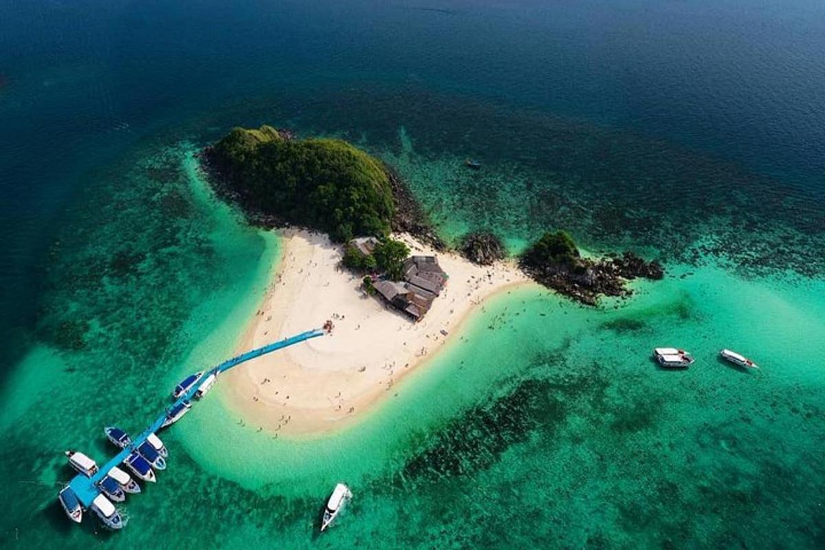 an island in the ocean with boats in the water