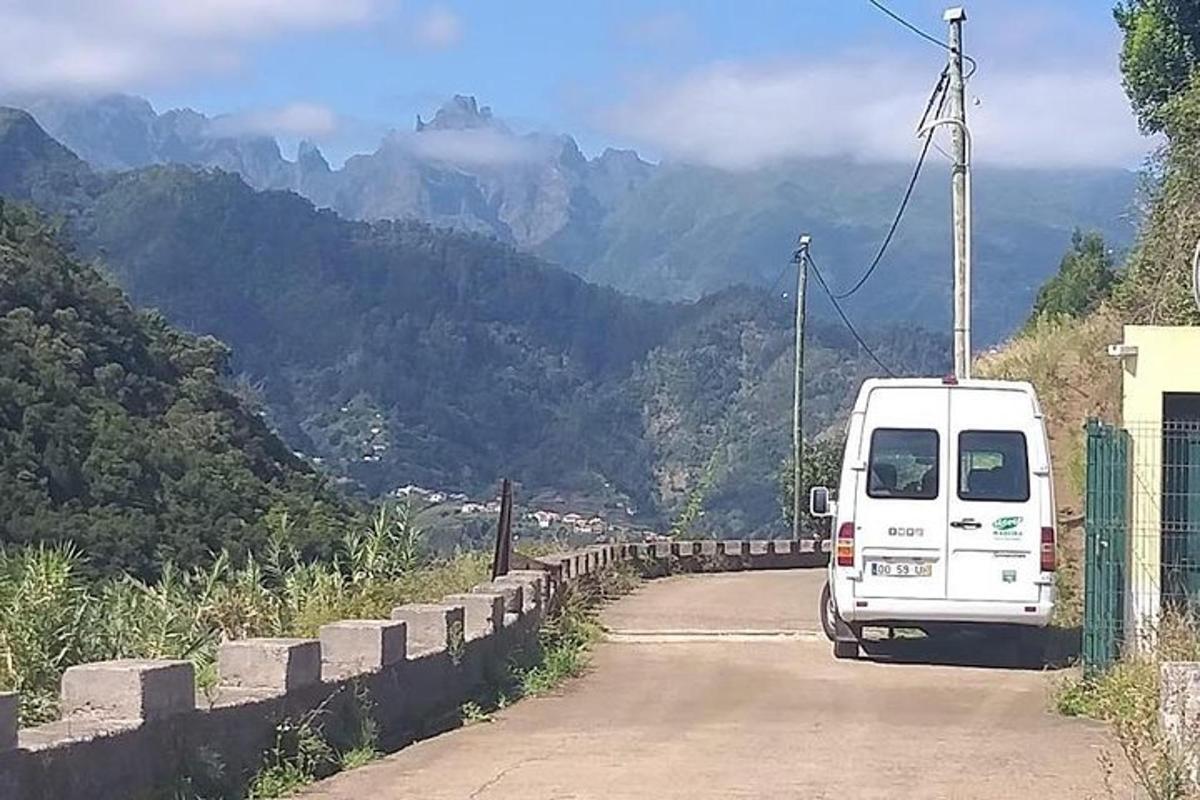 a white van driving down a road with mountains in the background