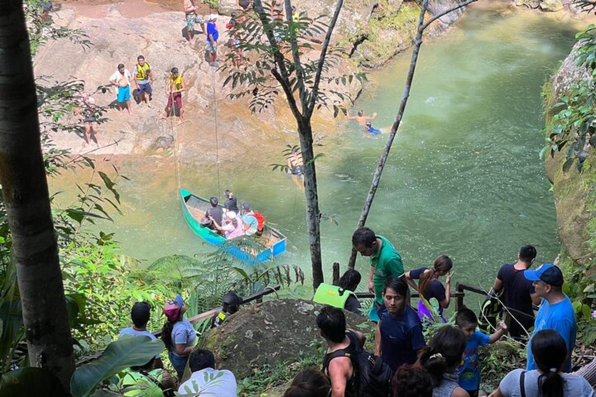a group of people watching people in a boat in a river