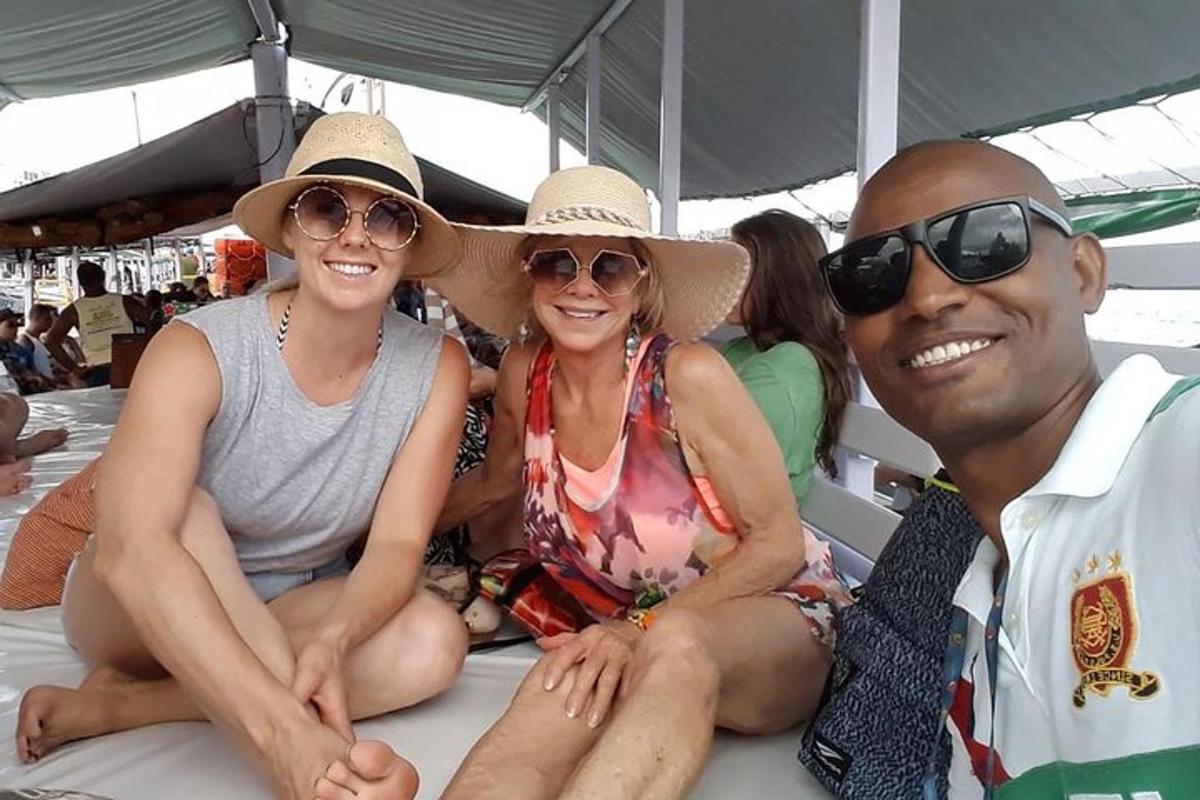 a group of three people sitting on a boat