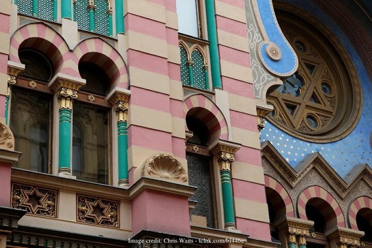 a building with pink and green trim with a window