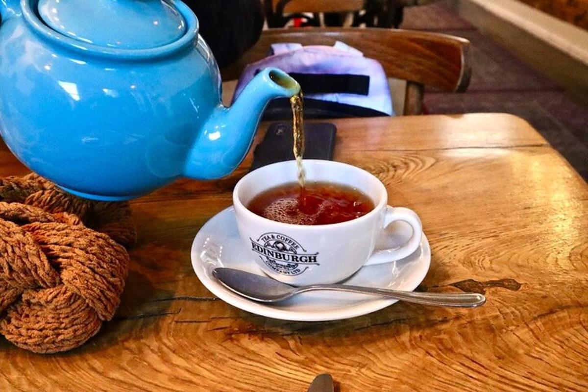 a cup of tea on a table with a teapot