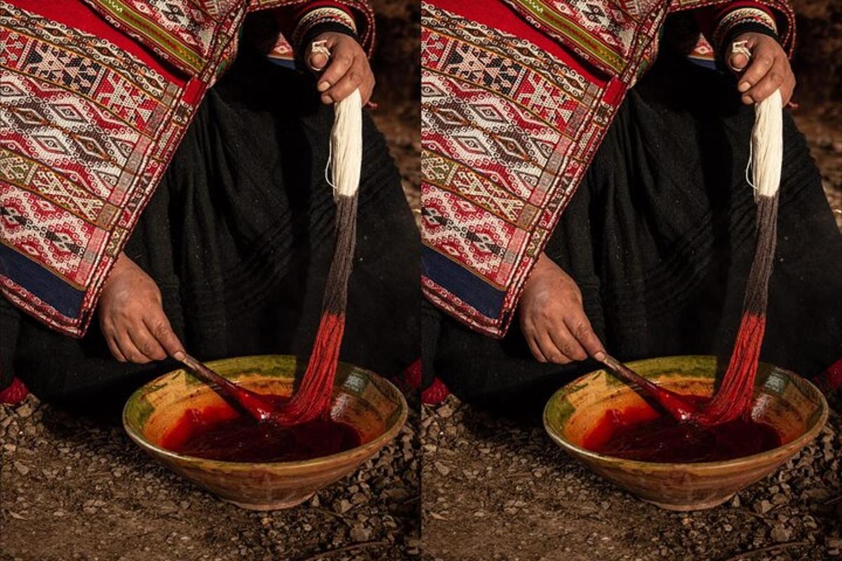 a person is holding a bowl of red sauce