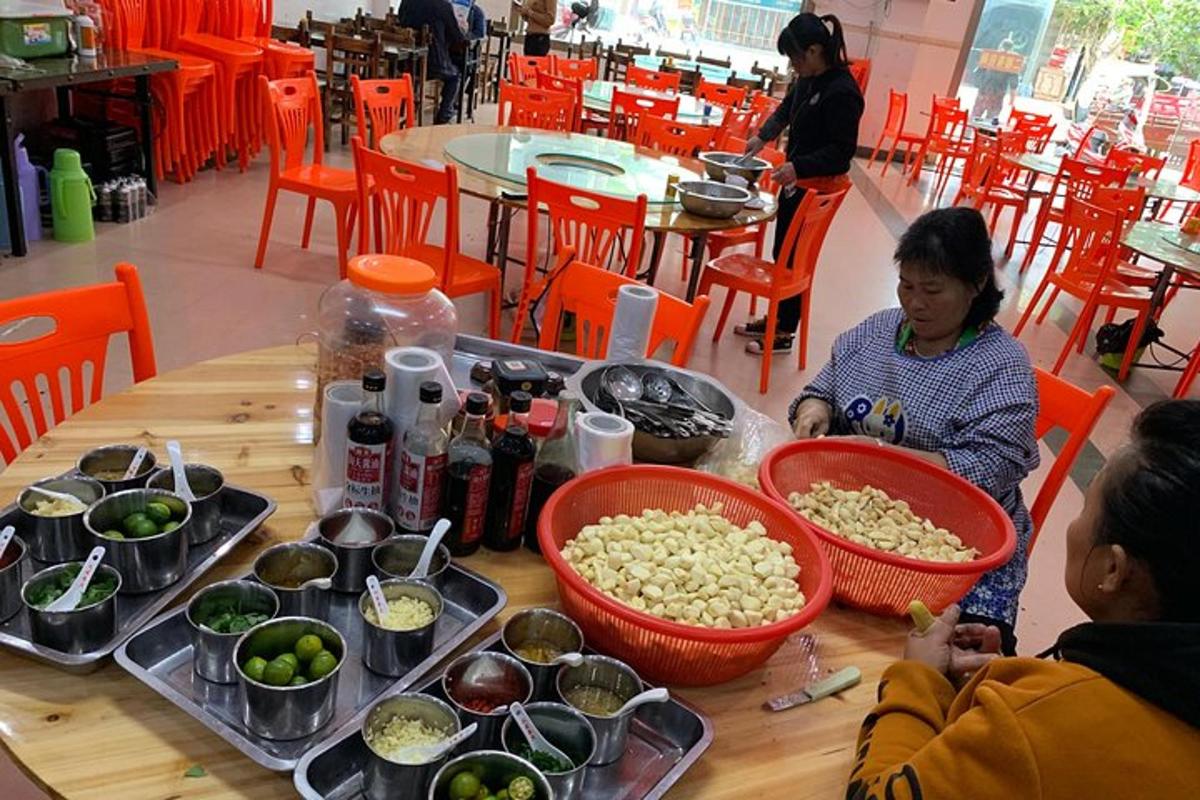 a woman sitting at a table with bowls of food
