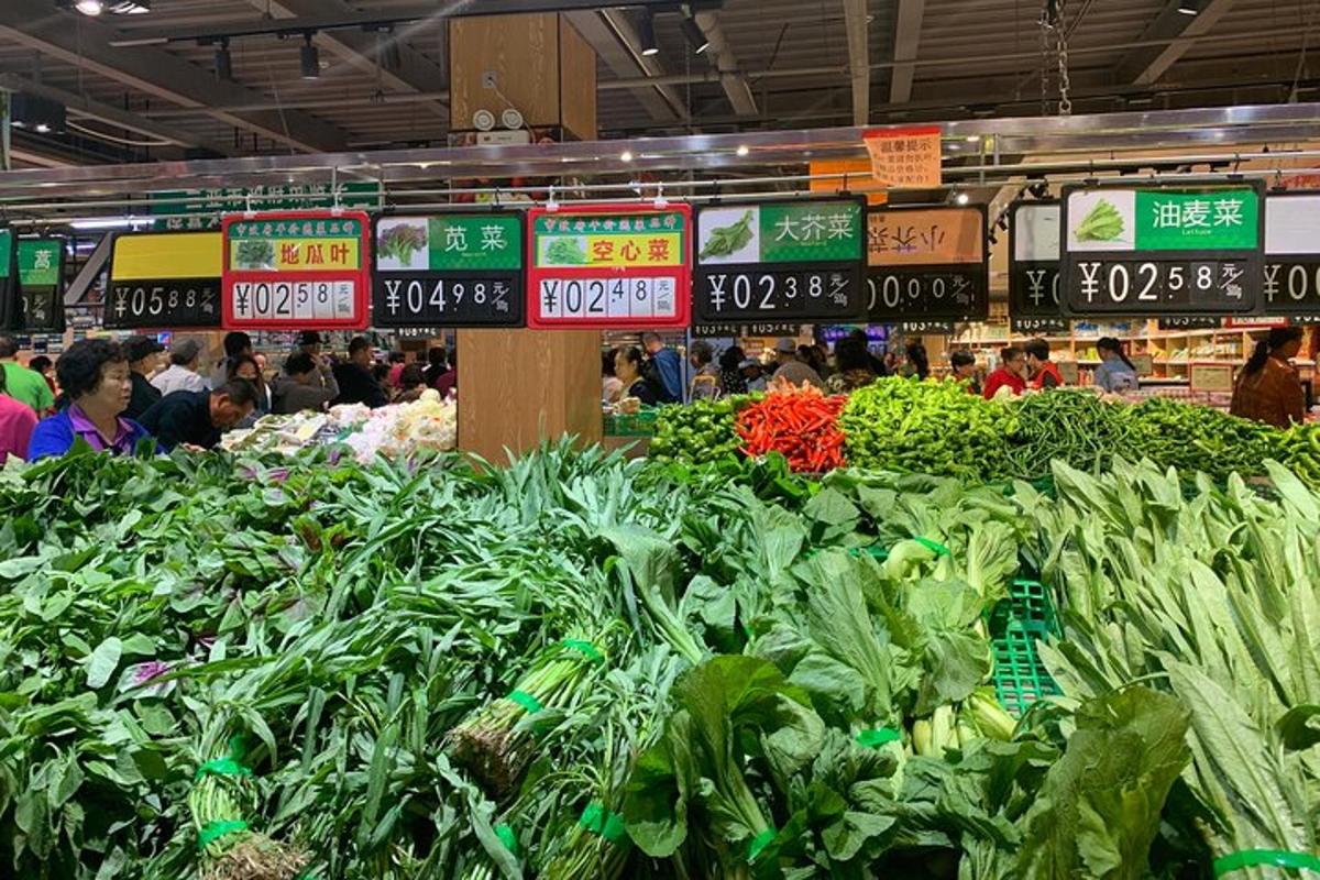a grocery store filled with lots of green vegetables