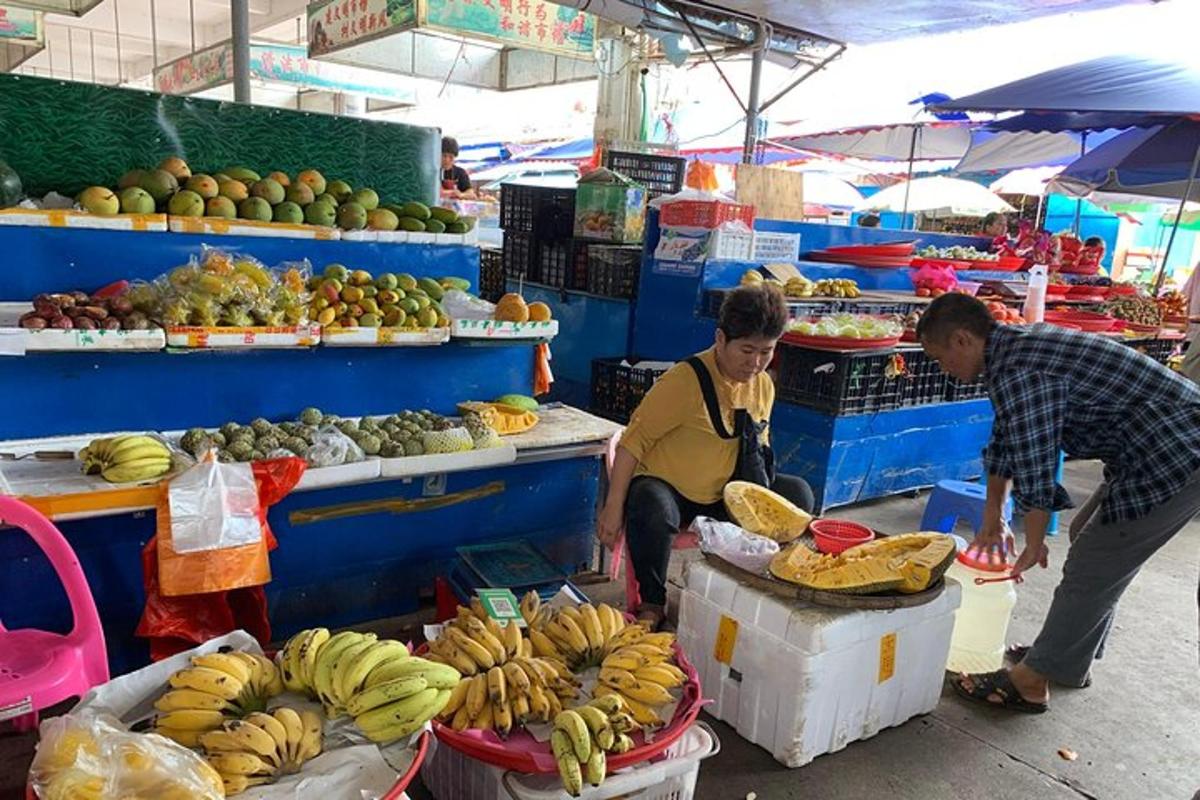 two people in a market with fruits and vegetables