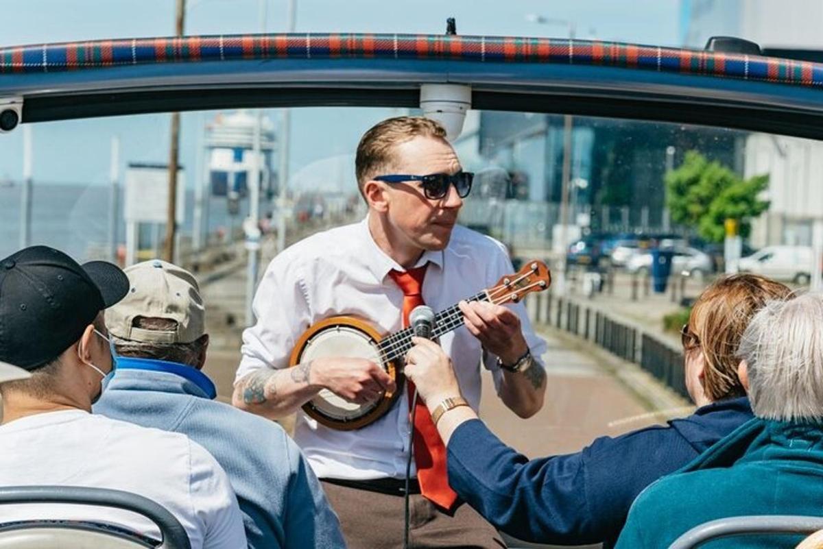 a man playing a guitar in a car
