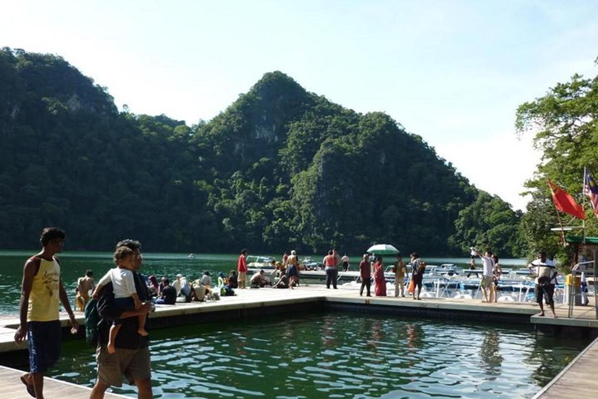 a group of people walking around a body of water