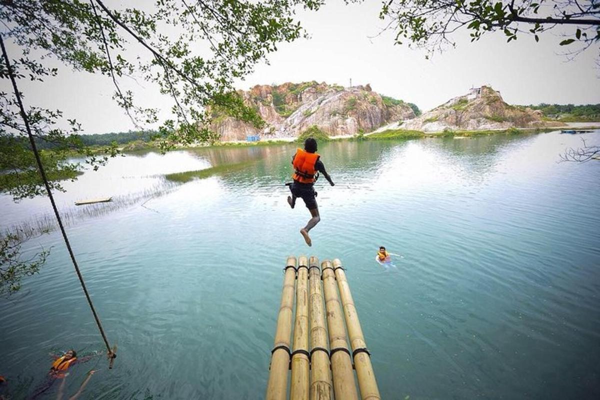a man jumping off a dock into a lake