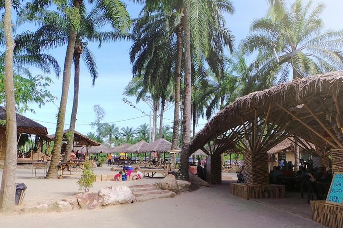 a resort with palm trees and people sitting at tables